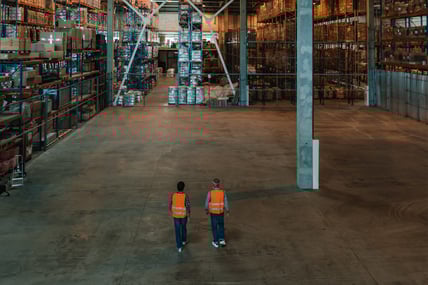 back-view-of-two-male-warehouse-workers-walking