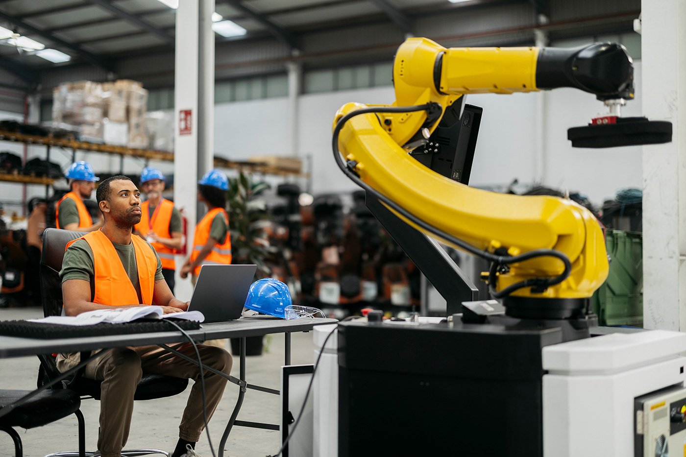 engineers-supervising-robotic-arm-in-modern-factor